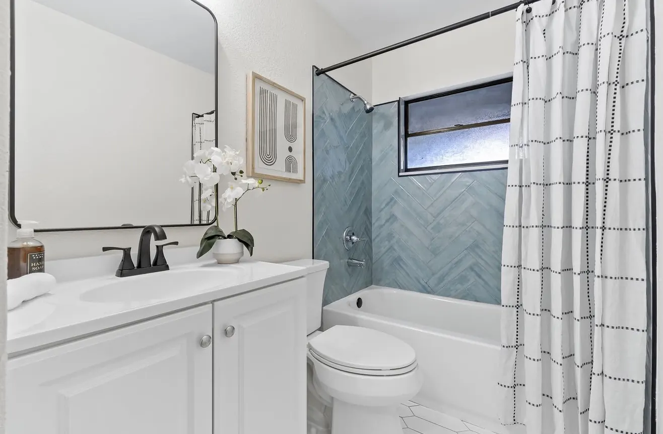 Tub surround with herringbone tile by CWL Construction