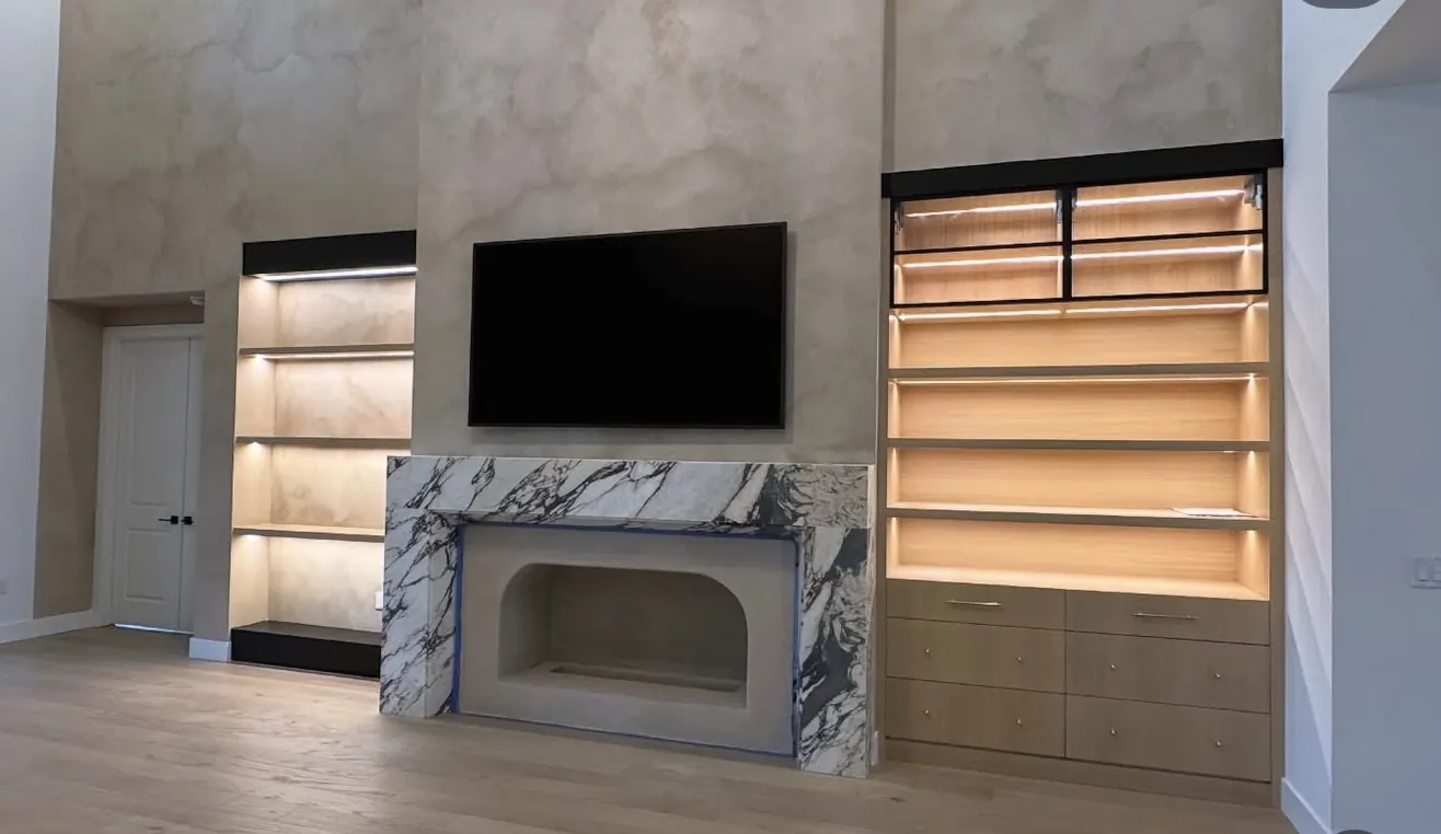 Feature wall, stone fireplace and lit built-ins by CWL Construction