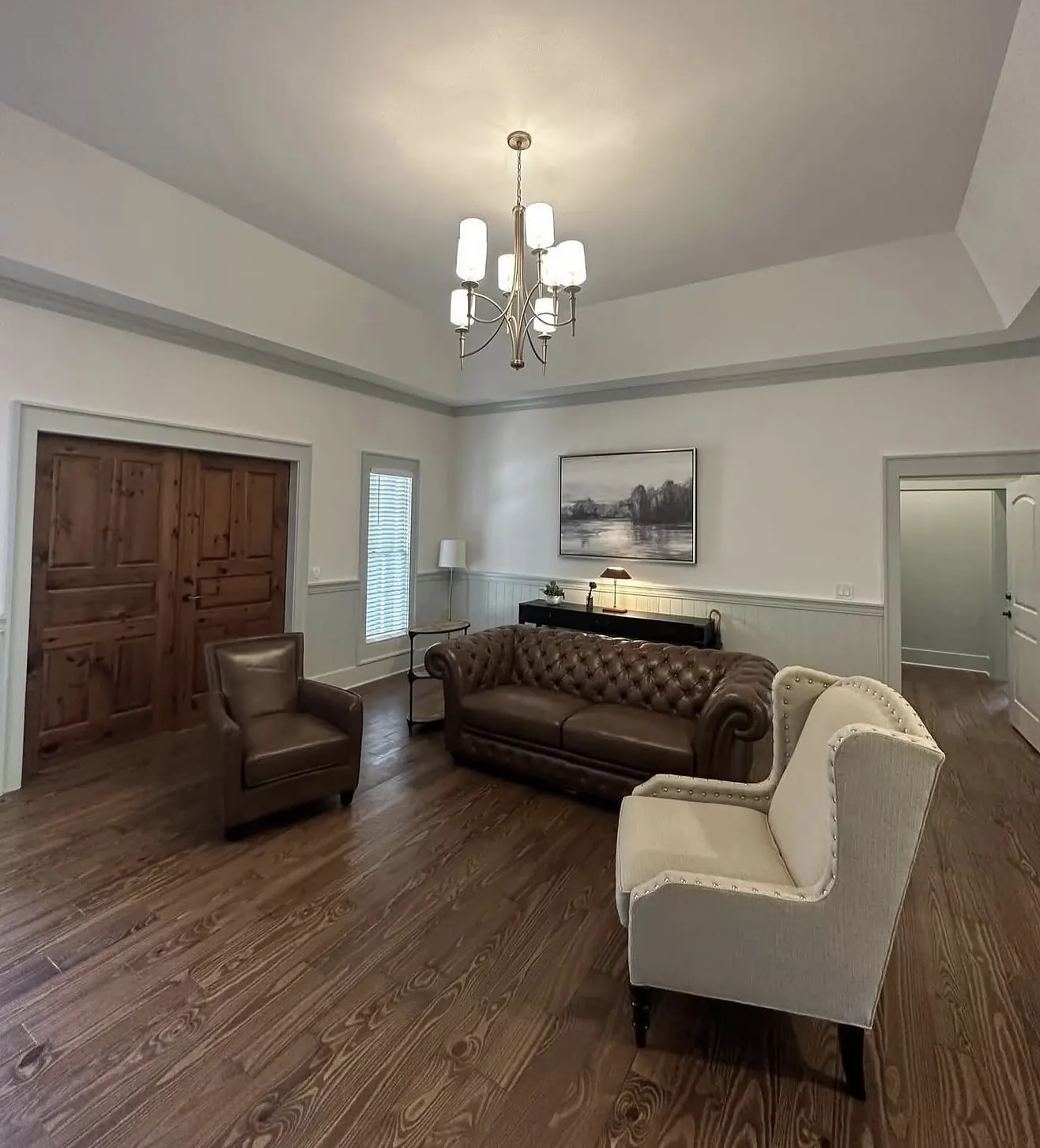 Living room with refinished hardwood by CWL Construction